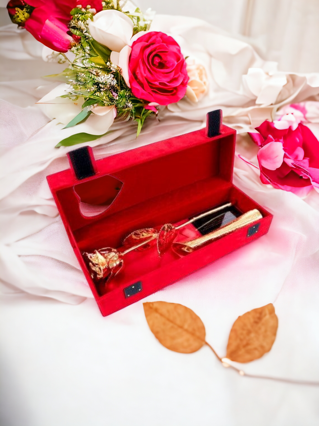Golden rose with golden vase on red velvet box